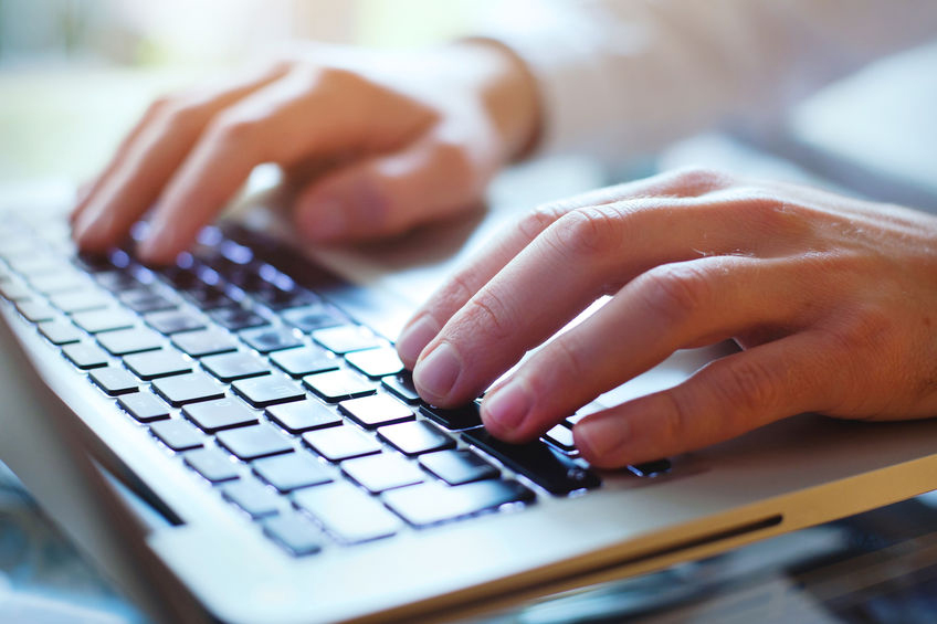 person typing on laptop