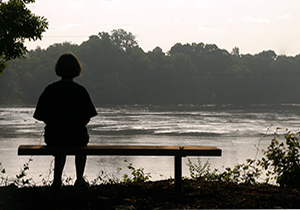 Person sitting on bench along Piedmont Medical Center Trail at Riverwalk